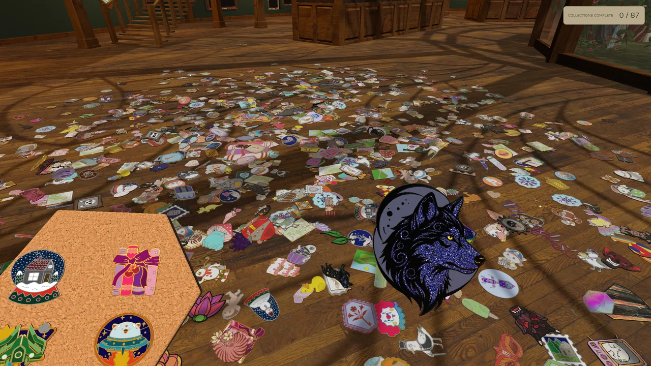 A blue dragon pin held above a wooden floor scattered with colorful enamel pins.